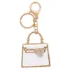 Porte clé Sc Crystal  B4309-DORE-BLANC