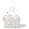 Image de MAÏKA Sac à langer | tendance | bandoulières et anses | waterproof | pochette élastiquée | grandes poches | matelas à langer inclus | Imprimé fleurs bleus sur fond écru (Field Flowers)