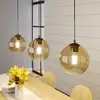 Image de Lindby suspension Sofian, amber, verre, 100 cm, à 3 lampes.