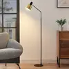 Image de Lindby lampadaire Vlada, 144 cm, laiton, noir, métal