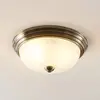 Image de Lindby plafonnier Pakka, laiton, verre, 31 cm, E27