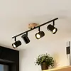 Image de Lindby plafonnier Xiomara, 4 lampes, longueur 68 cm, bois