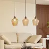 Image de Lindby Suspension Drakar, Ø 22 cm, 3 lampes, ambre, verre