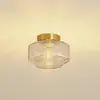 Image de Lindby Plafonnier Hildur, ambre, verre, Ø 22 cm