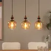 Image de Lucide Suspension Ilona, verre, noir/ambre, 3 lampes