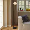 Image de Nordlux Lampe sur pied Wilson, métal noir, abat-jour sphérique en verre
