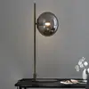 Image de Markslöjd Lampe à poser Dione, laiton/gris fumée, verre, fer