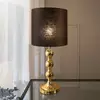 Image de Markslöjd Lampe à poser Octo abat-jour en tissu, laiton/noir