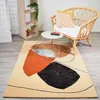 Image de tapis salon 160x230 fait main en laine beige et orange rectangle motif géométrique