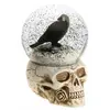 Image de Boule à neige Corbeau sur tête de mort résine 15,6cm C-12104