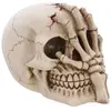 Image de Tête de mort résine déco avec main 16cm FETE-13075