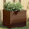 Image de Jardinière marron 36x30x32 cm résine tressée