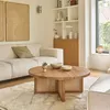 Image de Table basse ronde en teck pied cannage
