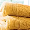 Image de Lot de 2 serviettes invité en éponge coton jaune ocre 33x50 cm