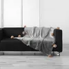 Image de Plaid à pompons 125x150 cm flanelle unie snowy gris