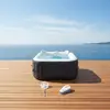 Image de SUNSPA AC01KITCD : Bain à remous gonflable rectangulaire pour 4 personnes, avec 130 micro-jets, jusqu'à 40 °C, capacité de 600 litres, dimensions 155 x 155 x 80 cm, livré avec une housse, un tapis de sol et 2 appuie-têtes