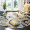 Image de SAFAVIEH Tapis Boho pour Salon, Salle à Manger, Chambre à Coucher - Monaco Collection, Tapis à Poil Court, Bleu et Multi, 91 X 152 cm