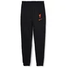 Image de Nike Liverpool FC, Pantalon de Jogging Homme, Saison 2022/23 Officiel Extérieur - Noir/Rouge - M